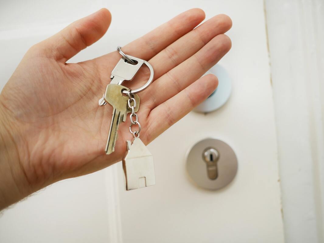 A hand holding house keys