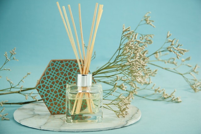 A fragrance diffuser in the form of a glass bottle with wooden sticks inserted in it, which can make the property smell wonderful, as it is suggested by one of these staging tips for your rental property.